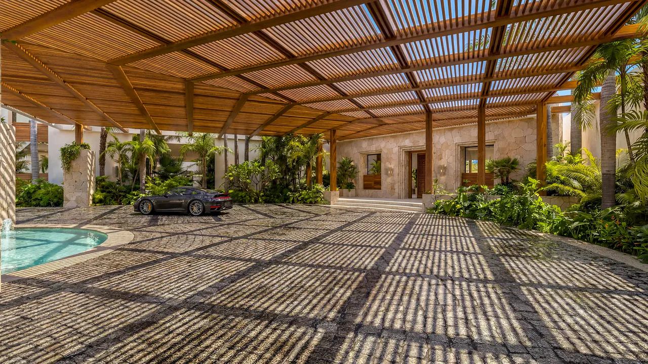 Clubhouse drive-up entrance beneath a timber pergola, with dappled shade on the paving, stone walls and greenery