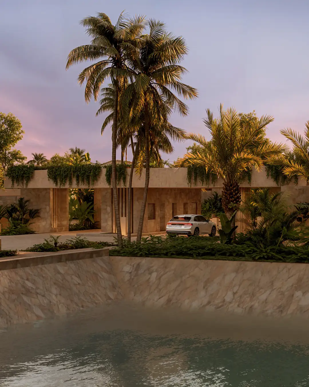 Serona's gatehouse seen from the canal at sunset, with stone wall and palm trees